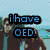 Pixelated image with text overlays and repeated triangular symbols over a blurred background of two people near water.