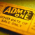 Pixelated yellow-orange gradient background with dark brown text reading 'All my love' in a stylized font, below which is partially legible smaller text.