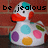 Pixelated image of a duck-like character with a red beak, white body, and colorful spots, set against a brown background with text above.
