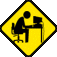 Four yellow diamond-shaped signs with black borders show a person at a desk in different poses: sitting upright, leaning forward, resting head on desk, and typing.