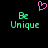 Pixelated green 'B' and 'Unique' text with a pink heart above, on black background.