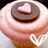 Pixelated image of a cupcake with pink frosting, brown swirls, and white icing details on the base.