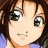 Pixelated anime-style character with brown hair and large green eyes, wearing a blue top, next to black background with white text.