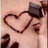 A pixelated heart outline in dark brown on a light pink background with partial dark shapes at the edges.