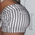 A person in a striped top with a visible back and shoulder, captured in a static image with no animation.