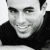 A 50x50 pixel animated buddy icon featuring a grayscale portrait of Enrique Iglesias on the left and green text "Original Icons .com" on a dark green background on the right, displayed as a contact sheet with two frames.