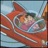 Red cartoon vehicle with white trim contains two characters in a cockpit, one with brown hair and another with pink hair, against a light blue background.