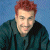 A 50x50 pixel buddy icon split into two sections: a person with red hair on the left and green text reading "Original Icons .com" on the right against a dark background.