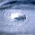 A pixelated image of a light-colored vehicle on a textured blue-gray background with a bright white highlight on the left side.