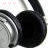 Black over-ear headphones with silver accents on a white background, featuring three pink heart icons above the left earcup that change position across frames.