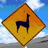 Yellow diamond-shaped warning sign with dark brown border, featuring a black silhouette of an animal resembling a llama or alpaca on a blue sky background.