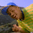 A pixelated image of a person in a yellow shirt and blue cap holding an object, with green text reading "K8 2K8" repeated on the right side and "GET JIGGY" below.