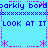 Pixel art icon with blue background, pink border elements, and repeated text "LOOK AT IT" in dark blue.