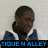 Pixelated image of a person with short dark hair wearing a white shirt and blue jacket, standing against light background with text below.