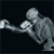 Pixelated grayscale icon of a boxer in mid-punch pose with extended arm and bent knee, set against solid black background.
