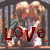 A pixelated static image shows two figures in a close embrace with the word 'LOVE' overlaid in bold red letters, set against a blurred background.