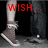 A four- shows a person's legs in dark pants and brown sneakers with white soles, each displaying red text reading "WISH...", "She Would... LOVE me.", against a black background