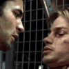 Animated sequence showing two people in profile view with a background, transitioning from side-by-side to close proximity with lips nearly touching