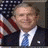 Pixelated image of a person in formal attire with an American flag background, next to text reading HERO crossed out and ZERO below it.