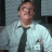 Pixelated image of a person in light shirt and dark tie with red text 'excuse me I believe you have' and partial stapler image.