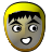 Pixelated cartoon face with yellow hair, black eyebrows, wide eyes, and a smiling mouth on a gray background.
