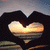 A heart-shaped hands silhouette frames a sunset over water, with text appearing sequentially across four