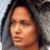 Pixelated close-up of a person's face with dark hair against a light background, showing partial facial features and skin tones.