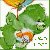 Green Care Bear holding orange fish in white bowl, yellow balloon with blue ribbon above; text 'wish bear' below.