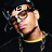 Pixelated image of a person with light skin wearing glasses, a dark cap, and a yellow-accented shirt against black background.