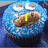 Blue cupcake with white eyes and brown mouth, displaying yellow text that changes across frames.