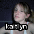 A four- shows a person in a white tank top with light brown hair tied back, against a dark background. Text overlays read "kaitlyn," "is," "sexy =]," and "lol."