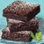 Stack of brownies with green accents on a light blue background, one version featuring text overlay.