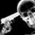 Static grayscale icon of a human skull with visible eye sockets and nasal cavity, rendered in pixelated style against black background.