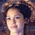 Pixelated portrait of a person with dark hair and light skin, facing left with neutral expression, against dark background.