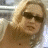A split-frame contact sheet showing a pixelated image of a person with blonde hair and sunglasses on the left, and green text reading "Original Icons .com" on a dark green background on the right.