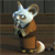 A pixelated cartoon fox with white and brown fur stands upright on a wooden background, wearing a brown outfit with a black collar.
