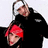 Two people pose together; one wears a white headband and black jacket, the other has bright red hair. Red text reads 'OTIS + BONEZ DUBB' on a black background.