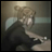 Pixelated image of a character with light brown hair and dark clothing, positioned next to text reading "AnimeIM" and "com" on a black background.