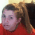 A pixelated image split into two sections: a person with light brown hair in a red top on the left, and a yellow background with purple text on the right.