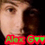 Pixelated close-up of a person's face with brown hair, featuring green text 'Alex G' and two heart symbols on red background.