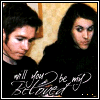Two people in black hooded garments stand against a patterned wall with text overlay reading "we'll always be my beloved".
