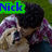 A person in a purple plaid shirt holds a light-colored dog against a green grass background, with text overlays changing across frames.