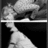 Black-and-white pixelated image with a grayscale figure and multiple text blocks in a digital font.