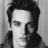 Black-and-white portrait of a person with tousled hair on left; blue background with pixelated text 'Jonathan Rhys Meyers' on right.