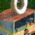 Pixelated image of a figure in motion with outstretched arms, wearing brown pants and dark blue shirt against green background.