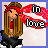 Pixel art buddy icon of a cartoon girl with long brown hair wearing red headband and shirt, standing next to stylized text "in love" in black-and-white checkered font on pink background.