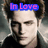 Pixelated image of a person with dark hair wearing a black top, overlaid with blue and pink text reading 'In Love' above the head.