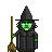 Pixel art of a green-skinned witch with a tall black hat, dark robe, and broom, standing against a gray background.