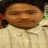 Pixelated close-up of a person with closed eyes wearing light-colored clothing and dark hair against a blurred background.