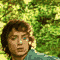 25 pixelated character portraits with varying expressions against a green foliage background, each wearing a teal shirt